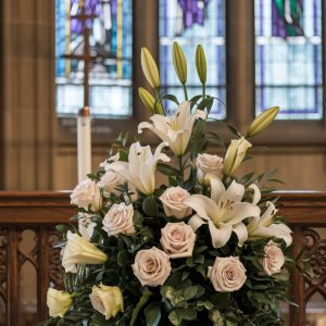 A gorgeous mix of ivory roses and white lilies sit on display at a church in Chicago's Edison Park neighborhood.